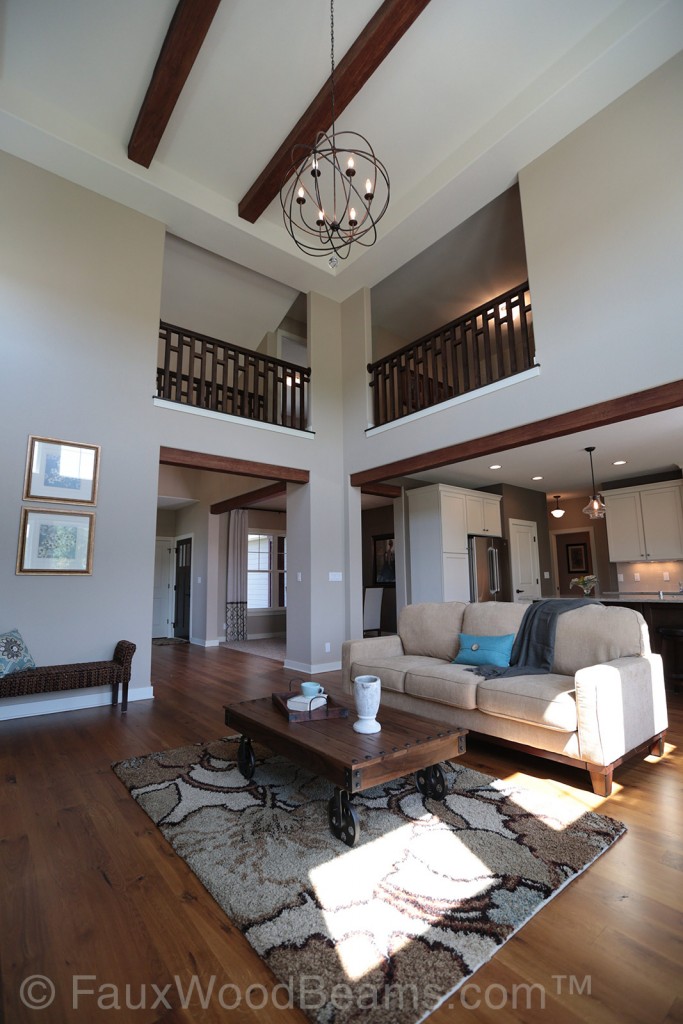 Open plan living room with faux Beachwood beams and wire orbital chandelier.