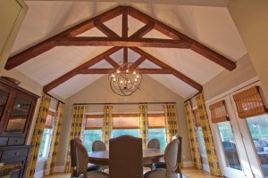 Dining room remodeled with standard King truss made with Custom Timber beams and orbital chandelier