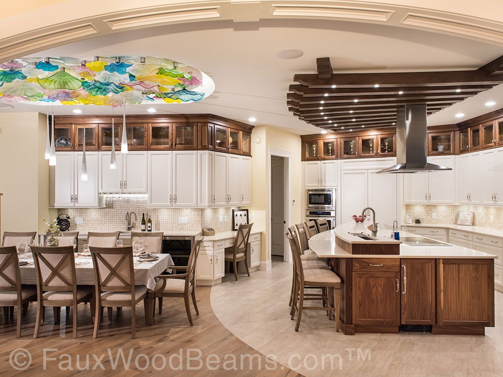 Aspen beams arranged in a railroad track pattern complement this modern kitchen's wooden cabinets.