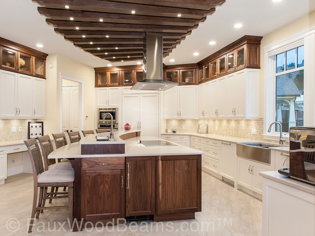 Modern white kitchen accented with a ceiling treatment built with hollow beams.