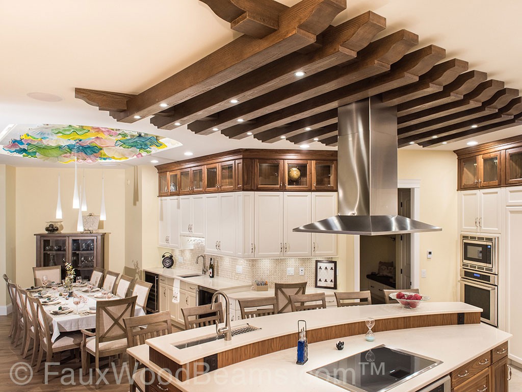 Kitchen ceiling treatment made Custom Aspen Beams hangs above the kitchen island.