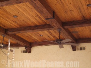 A beamed ceiling with end to end joints covered with rubber straps that mimic real cast iron.