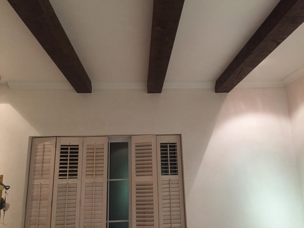 Do it yourself ceiling beams stained and installed by the homeowner himself.