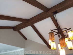  This design makes it appear like the supporting beams are exposed, including the main beam running along the apex of the roof.