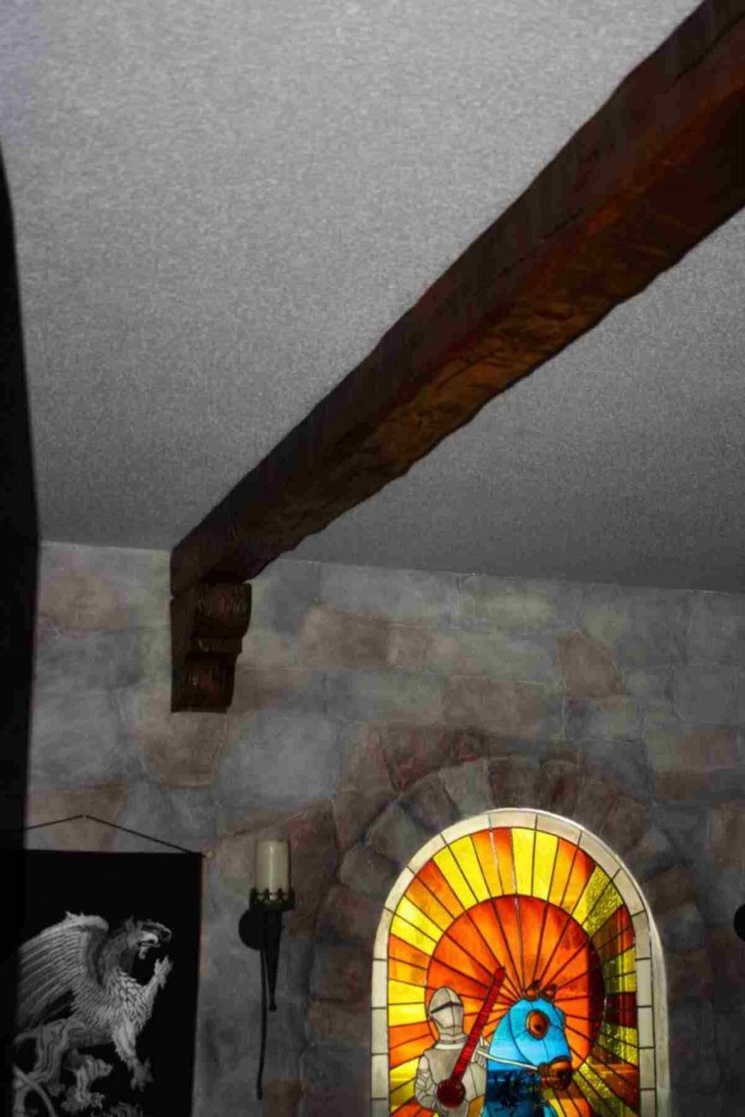 Medieval style bedroom with faux beam and corbel.