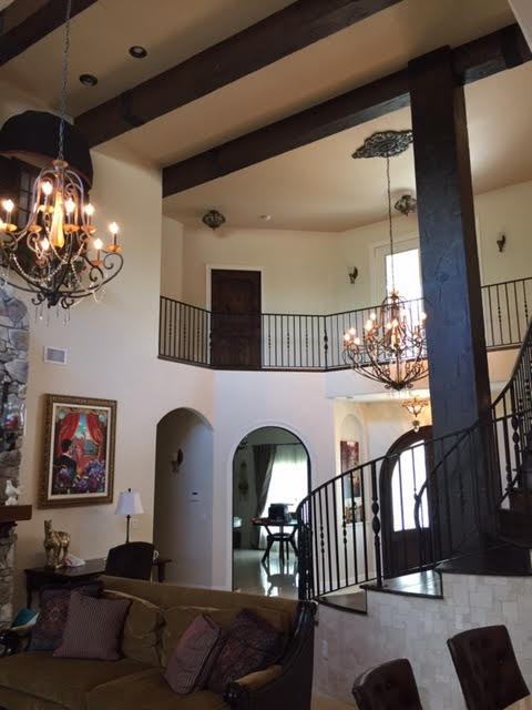 Floor to ceiling view of Tuscan style manor built in 2014 and decorated with custom faux wood beams.