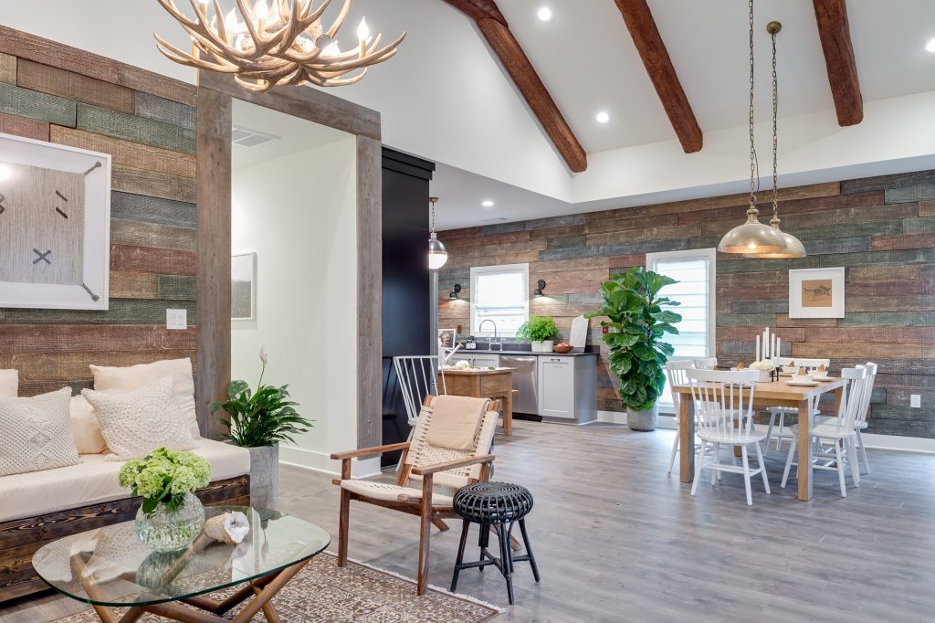 Open plan, custom home built on the Home Free TV show, featuring rustic wood panels and beams.