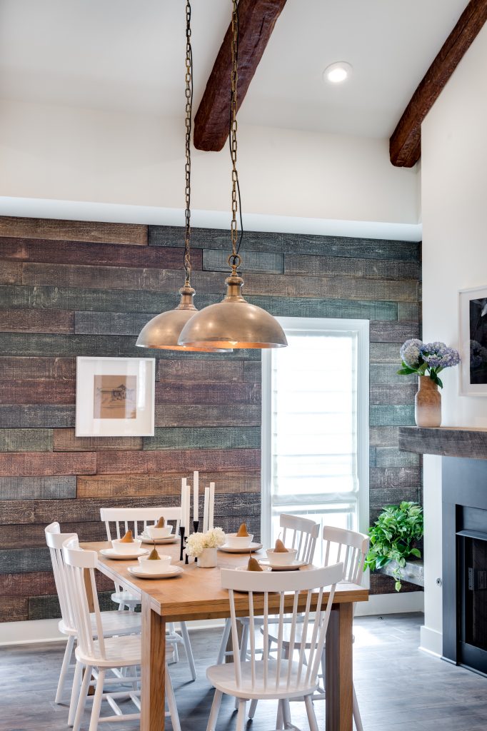 Dining area of the modular home built on Home Free, with wood style beams and panels lending a timeless look