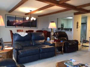 Living room sheetrock ceiling seams covered with lightweight, polyurethane beams.