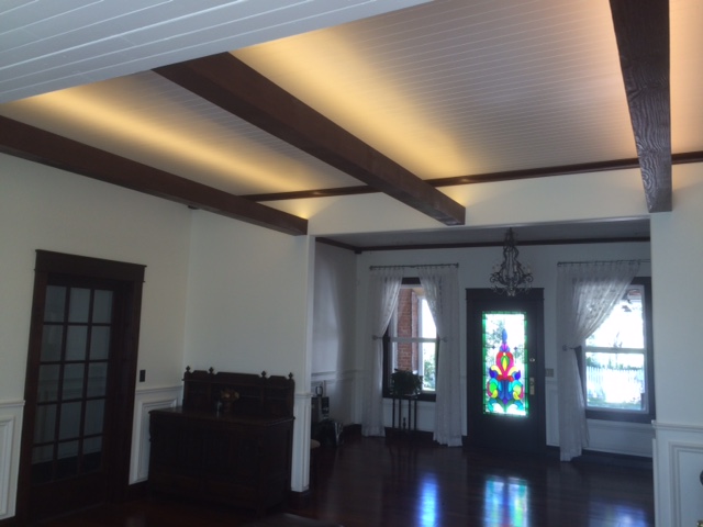 To reinforce the Craftsman style for her home, a homeowner stained these unfinished suspended beams to match the rest of the wood in the house.