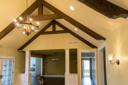 The pattern of these beams mimics how real wooden beams would have supported the ceiling of a traditional wooden-framed house.