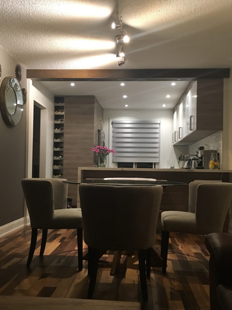 A home's ugly ceiling seam between adjoining kitchen and dining room is easily covered with a single faux wood beam.