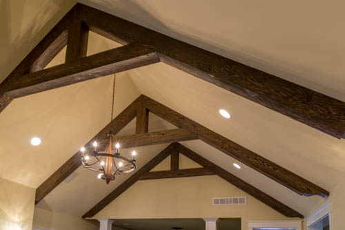 Great room ceiling trusses made with faux wood beams