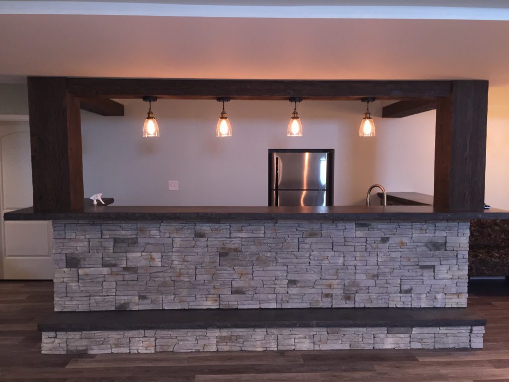 A finished basement bar built by the homeowner with the look of real wood and stone.