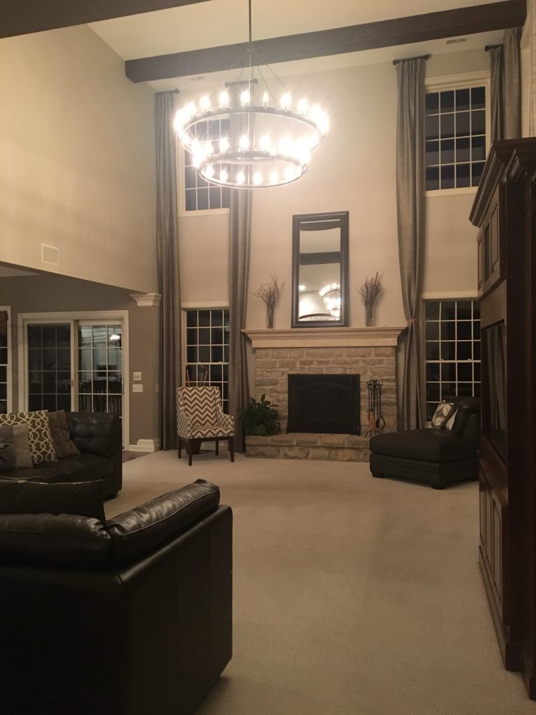 High-ceiling living room remodeled with Tuscany Beams.