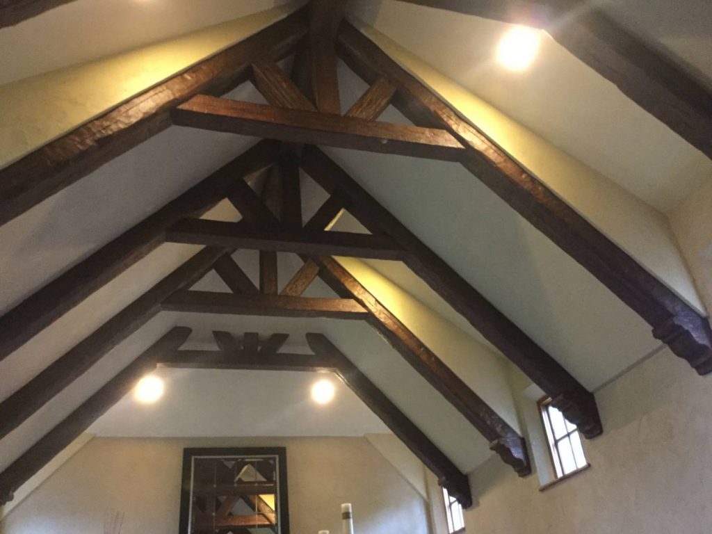 Cathedral trusses made from Custom Timber beams with corbel accents installed on a home's ceiling.