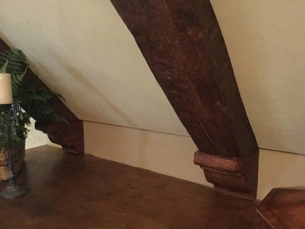 Corbels added to the ends of a ceiling truss to reinforce the authentic look.