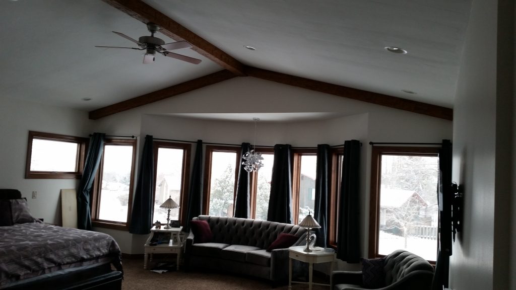 New home design with Rough Hewn beams added to the master bedroom's ceiling.