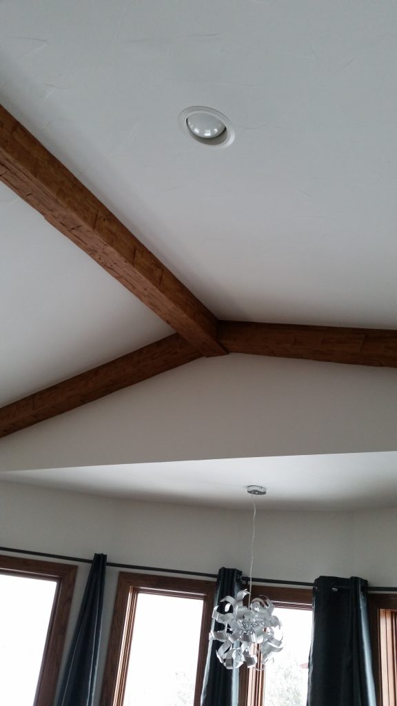 Close up view of Rough Hewn beams joined together in a new home's bedroom.