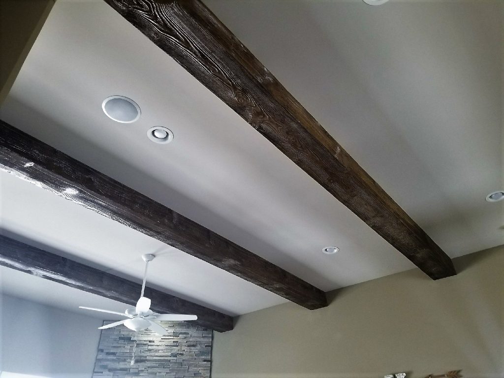 Great room remodel with Beachwood beams installed on the ceiling.