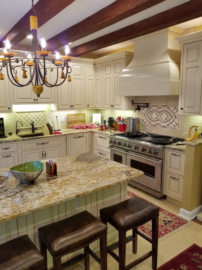 With beautiful new cabinets, gleaming subway tiles and faux beams, Sara's kitchen redesign looks fantastic.