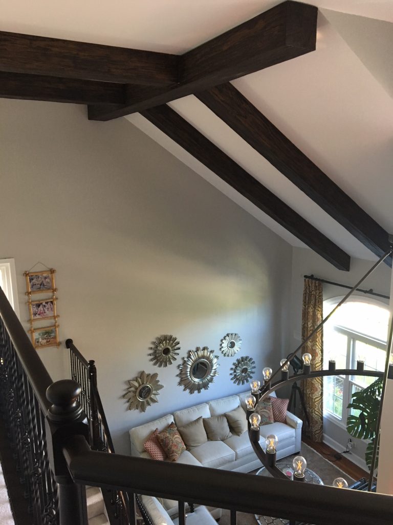 Medieval style added to a living room's high vaulted ceiling with Custom Heritage Beams.