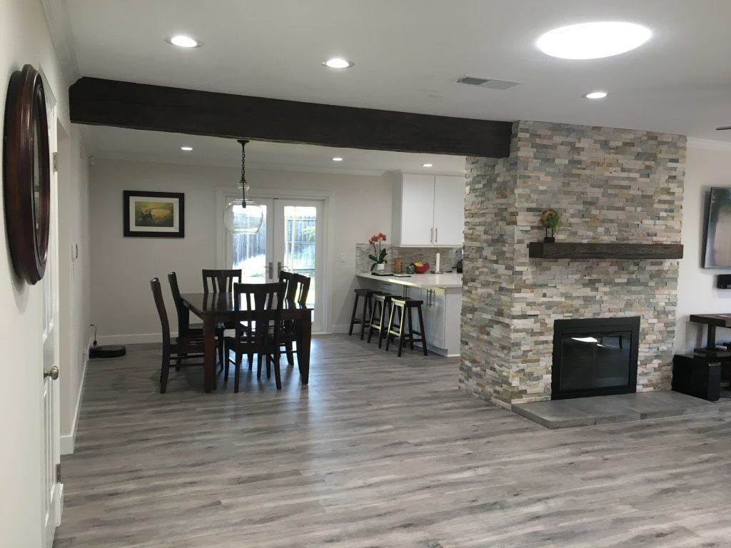 Open plan living room and kitchen, newly remodeled with a Custom Timber beam and mantel.