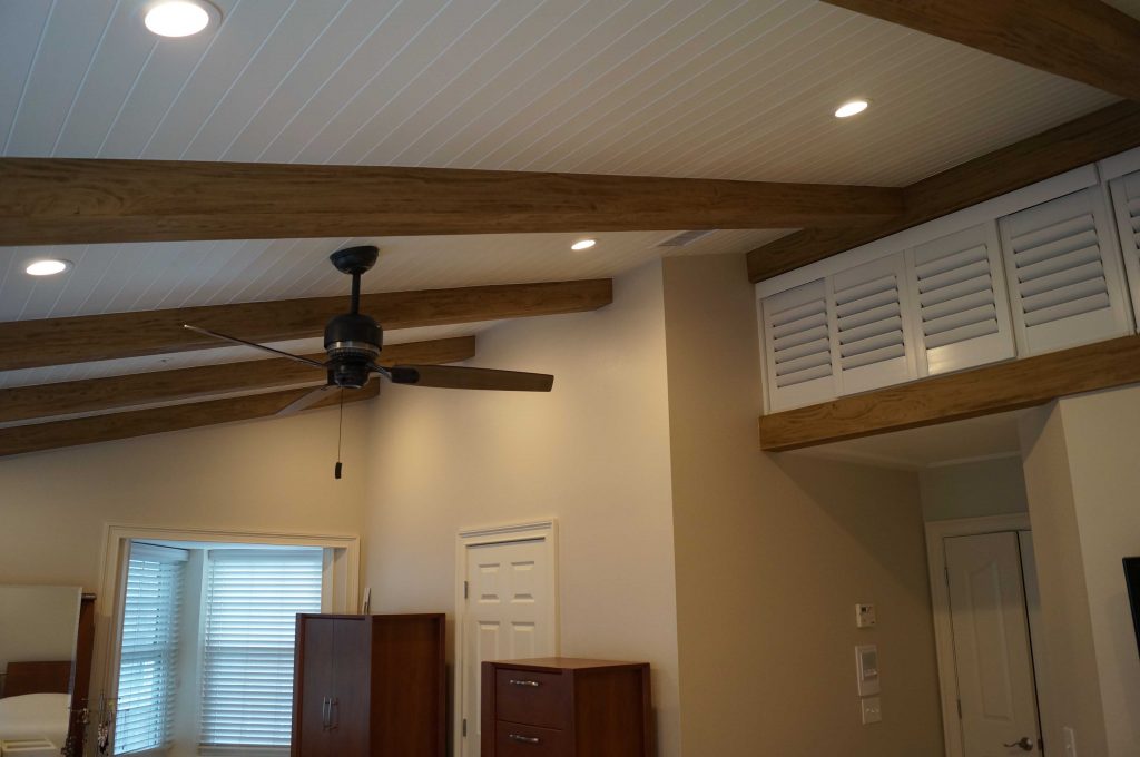 Bedroom ceiling beams match the framing around the cupboards.