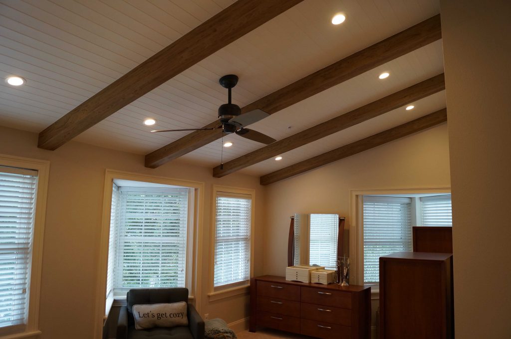 Ceiling beams add some custom character to a redesigned bedroom.