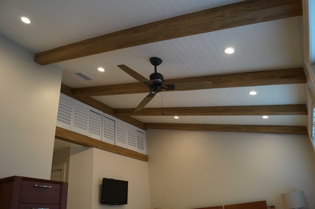 Bedroom after photo: Custom Driftwood Beams extend across the newly installed beadboard.