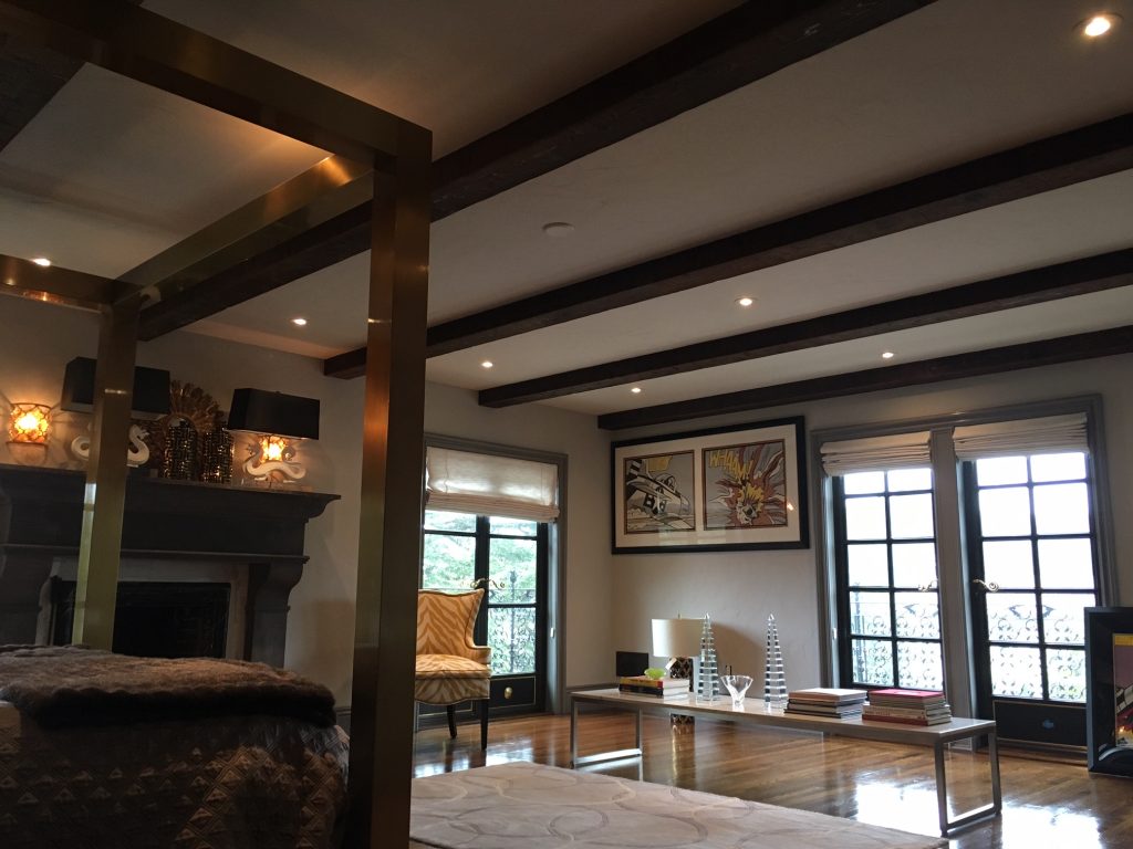 Master bedroom design featuring real wood exposed box beams.