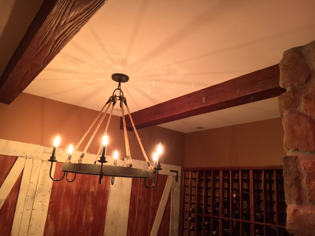 A home wine cellar remodeled with faux sandblasted beams that match the historic decor.