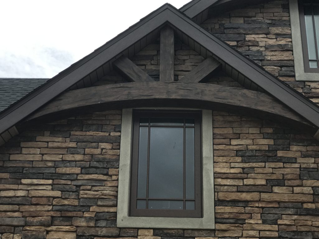 Decorative gable truss made with curved and straight Hand Hewn beams.