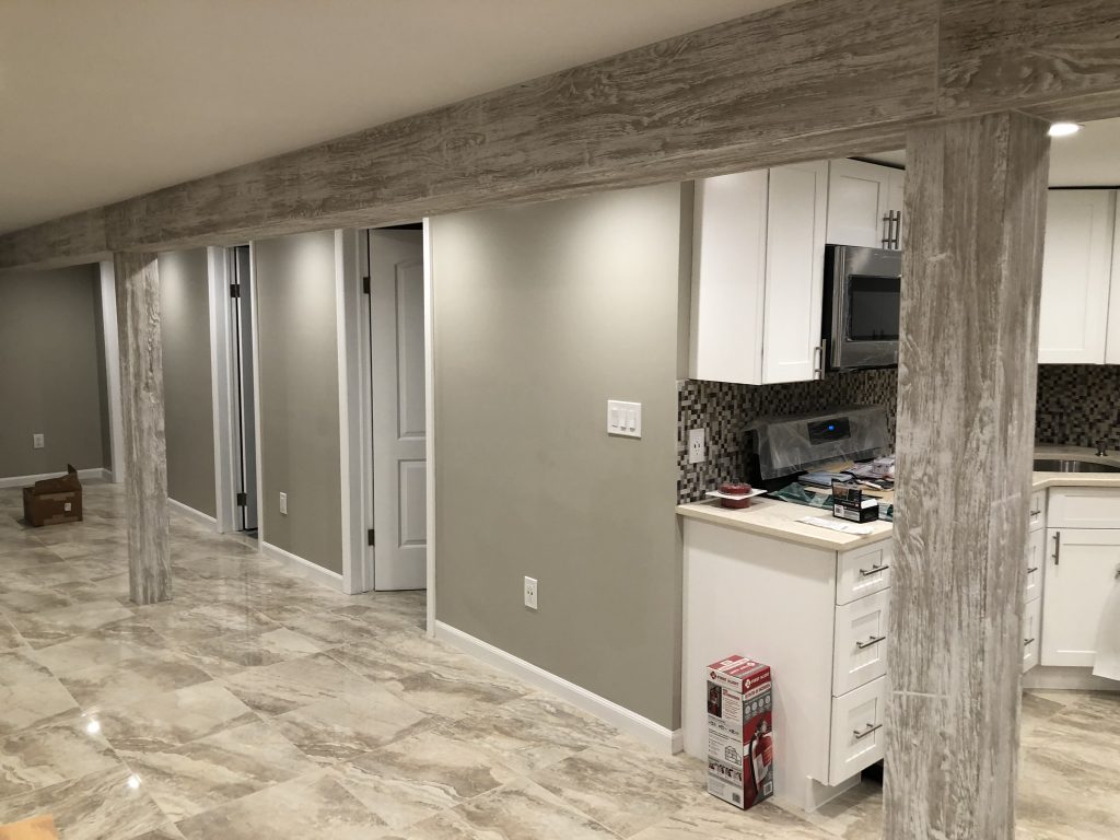 Finished basement support columns covered in Custom Driftwood Beams in White Wash stain.