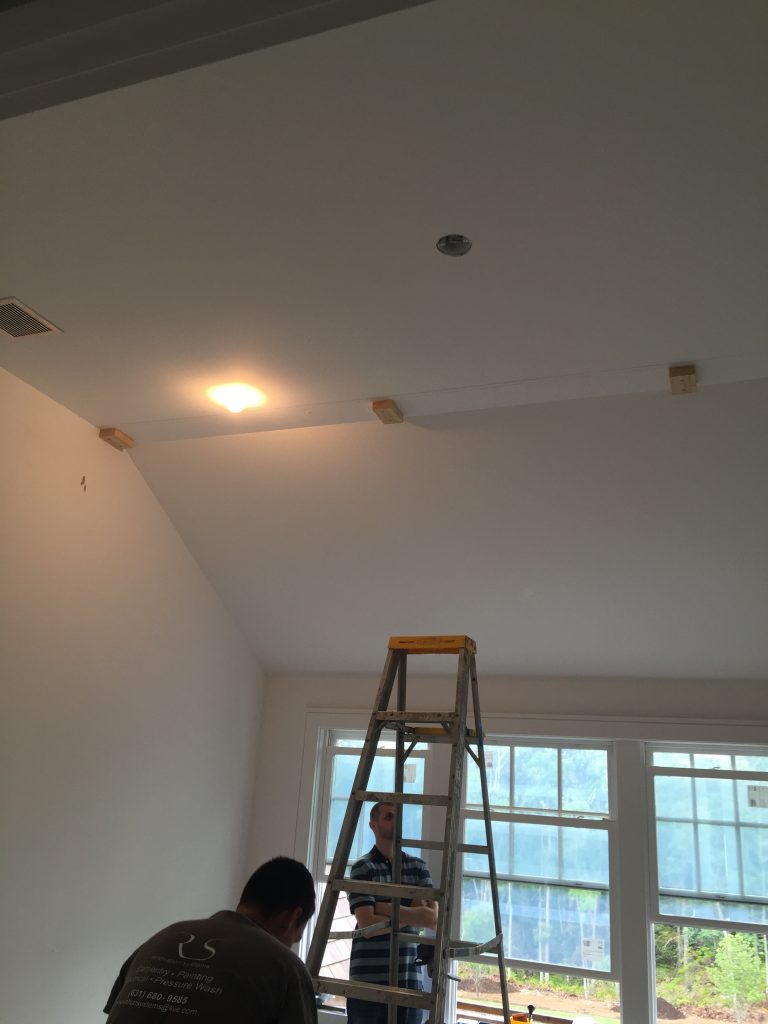 The new ceiling was finished with drywall and plaster, and then the placement of the beams was plotted out and marked with mounting blocks.