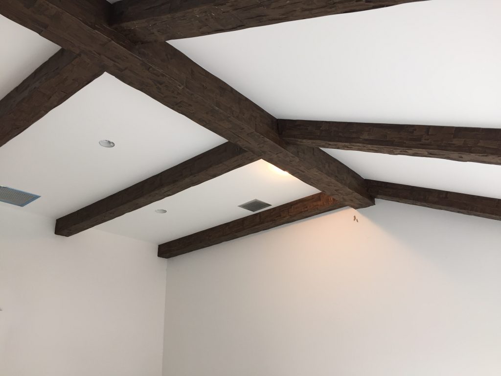 Ceiling beam installation finished on a bedroom vaulted ceiling.