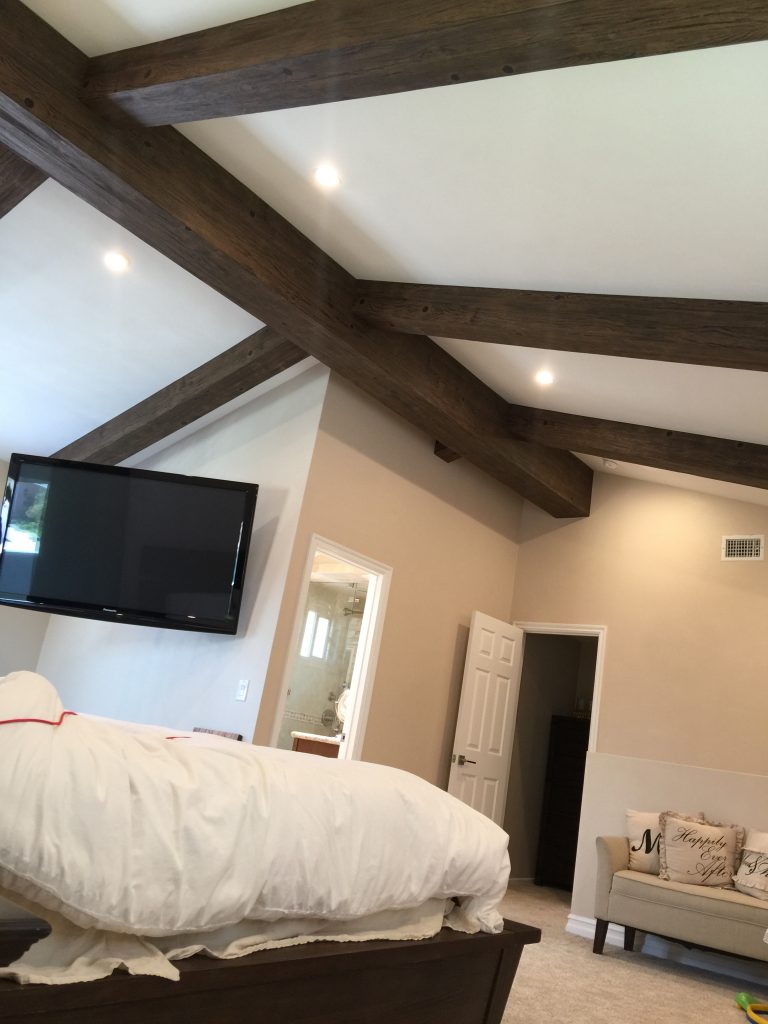 Completed master bedroom makeover including new Custom Driftwood beams on the ceiling.