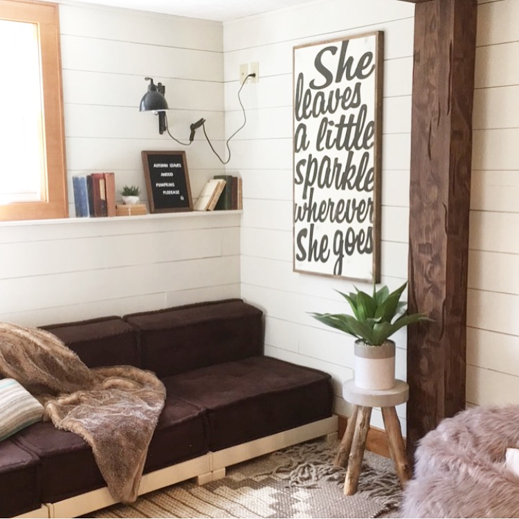 Bedroom reading nook framed with a faux wood beam.