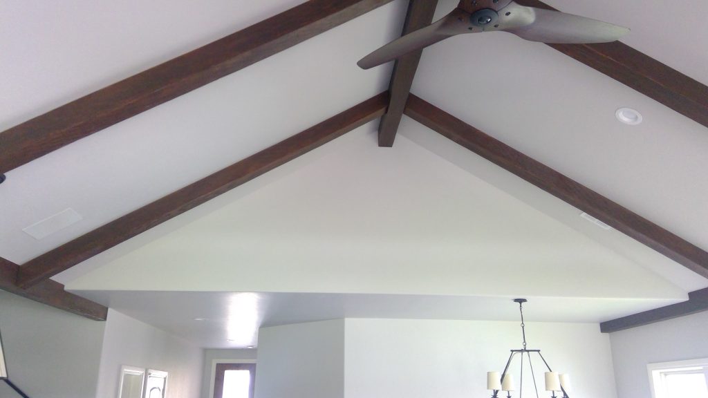 Unfinished faux ceiling beams custom stained.