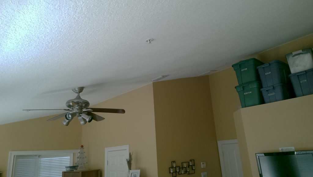 BEFORE: Dated popcorn ceiling and drab design also spoiled the bedroom.