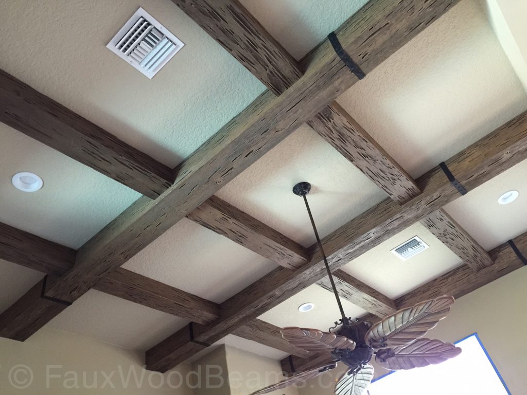 A coffered or grid-designed ceiling crafted out of faux wood beams