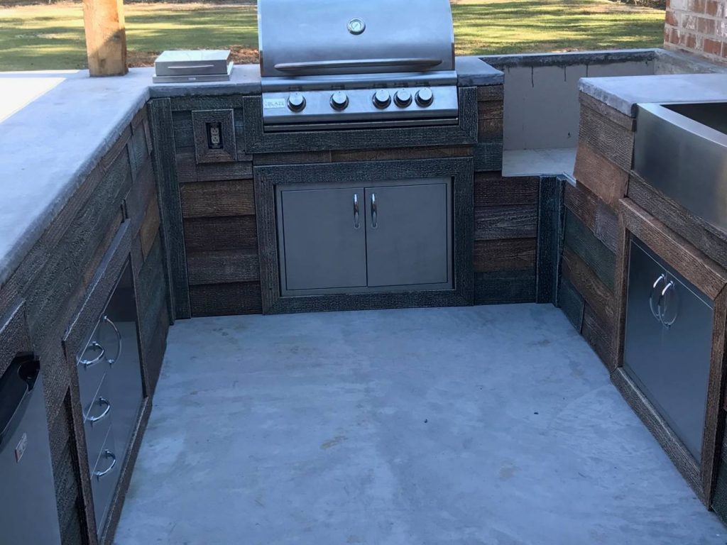 Outdoor kitchen frame covered in Wellington Reclaimed Barnboard Shiplap panels.