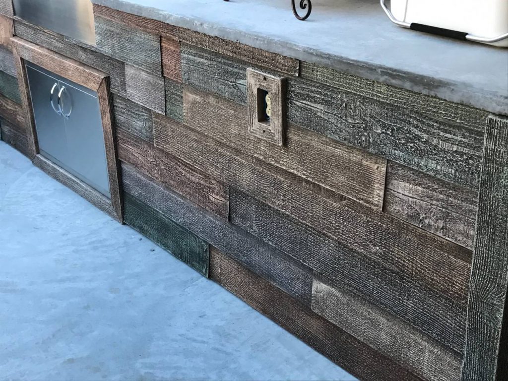 Close up view of outdoor kitchen built by a DIY homeowner with a rustic wood look.