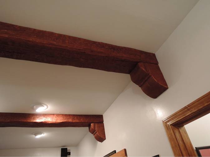 Timber style beams with corbels attached.