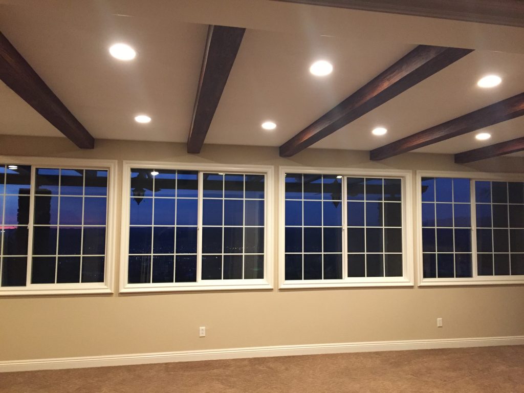 Living room's new ceiling beams, perfectly spaced to look like authentic exposed timber.
