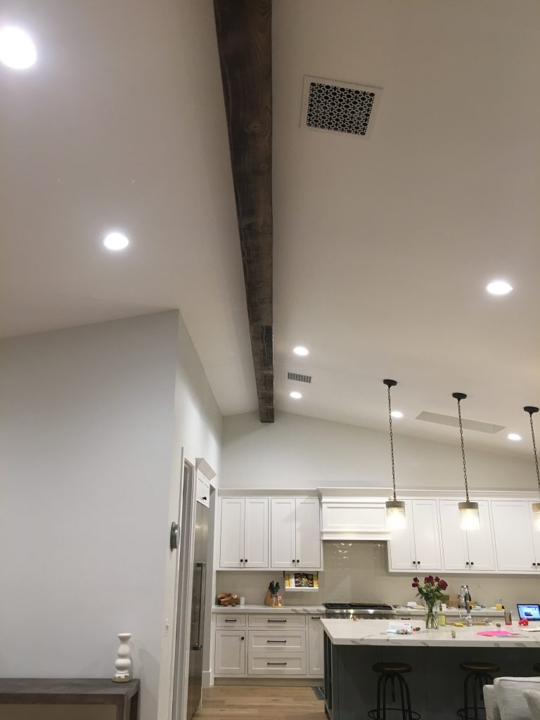 This large beam installed on a kitchen ceiling is actually two lengths of faux beams joined to span its over 30 foot length.