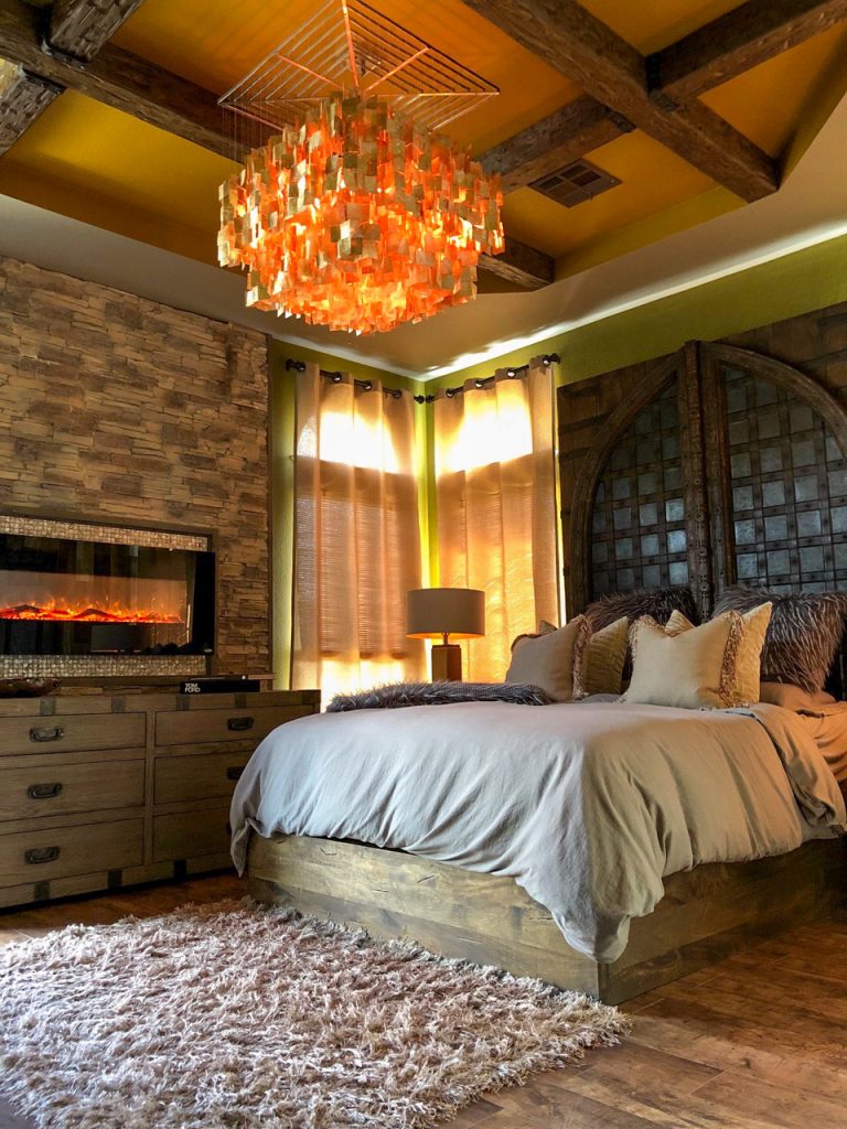 Luxury master bedroom with Custom Tuscany beams installed on the tray ceiling.