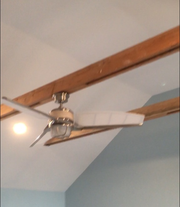 Suspended beam with ceiling fan.