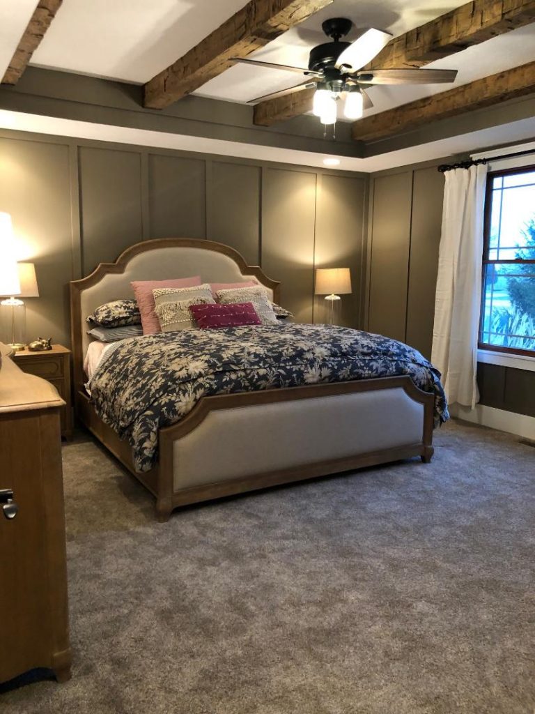 A bedroom's color scheme flows in perfect harmony with the walnut-stain of the ceiling beams matching the furniture.