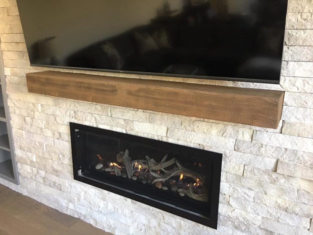 Floating fireplace mantel, Beachwood style installed between a living room's fireplace and TV.